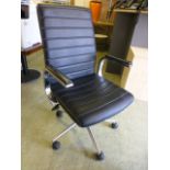 A black leather effect office chair on five star base