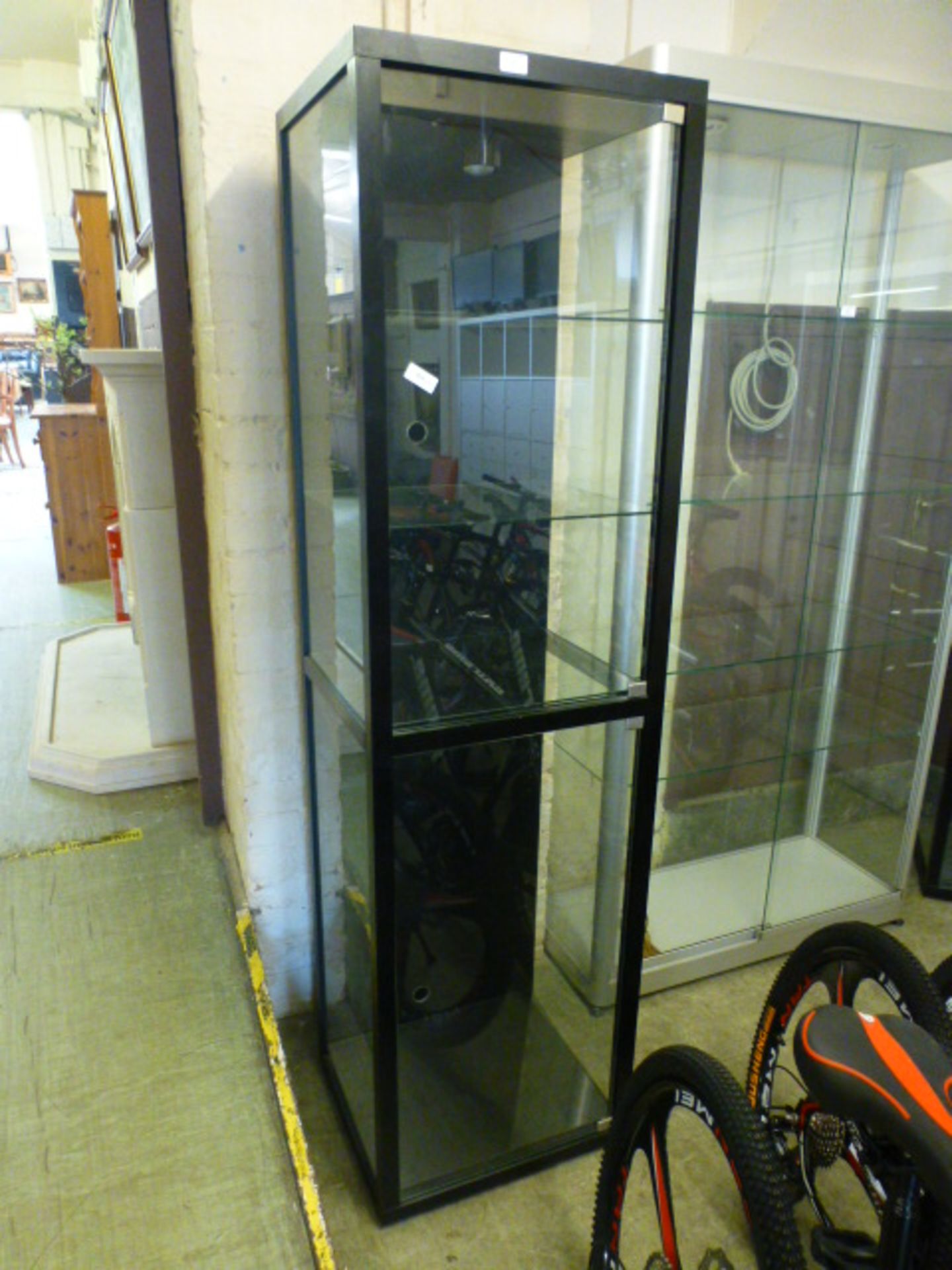 A black framed and glazed display cabinet, h.