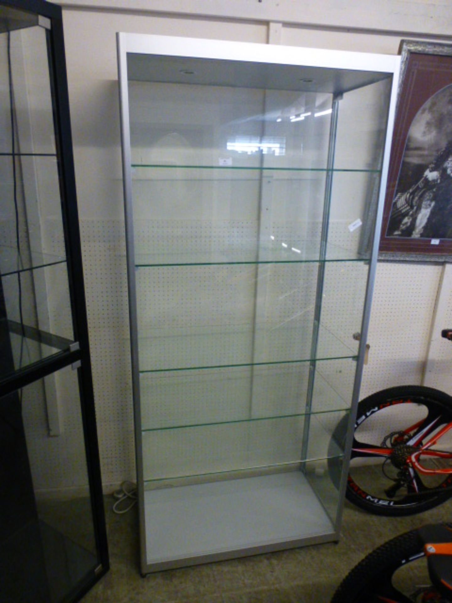 A metal framed display cabinet with five adjustable shelves and two side doors, h.