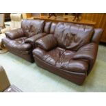 A pair of brown leather chairs