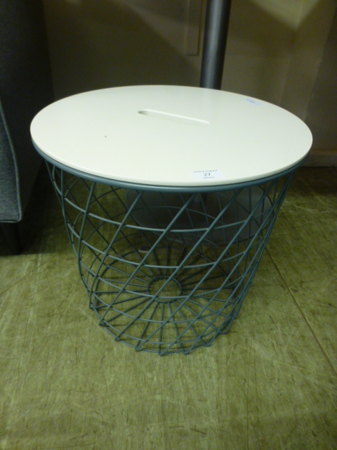 A waste paper basket with lid