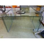 A curved glass table/desk