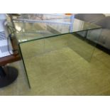 A curved glass table/desk