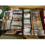 Two trays of DVDs and videos to include James Bond and other titles