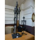 Two wrought iron fireside companion sets