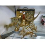 An assortment of brass items to include a hand bell, model of an eagle, horse and cart etc.