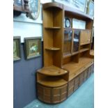 A full height mid-20th century design teak corner cabinet having open torage above a pair of doors