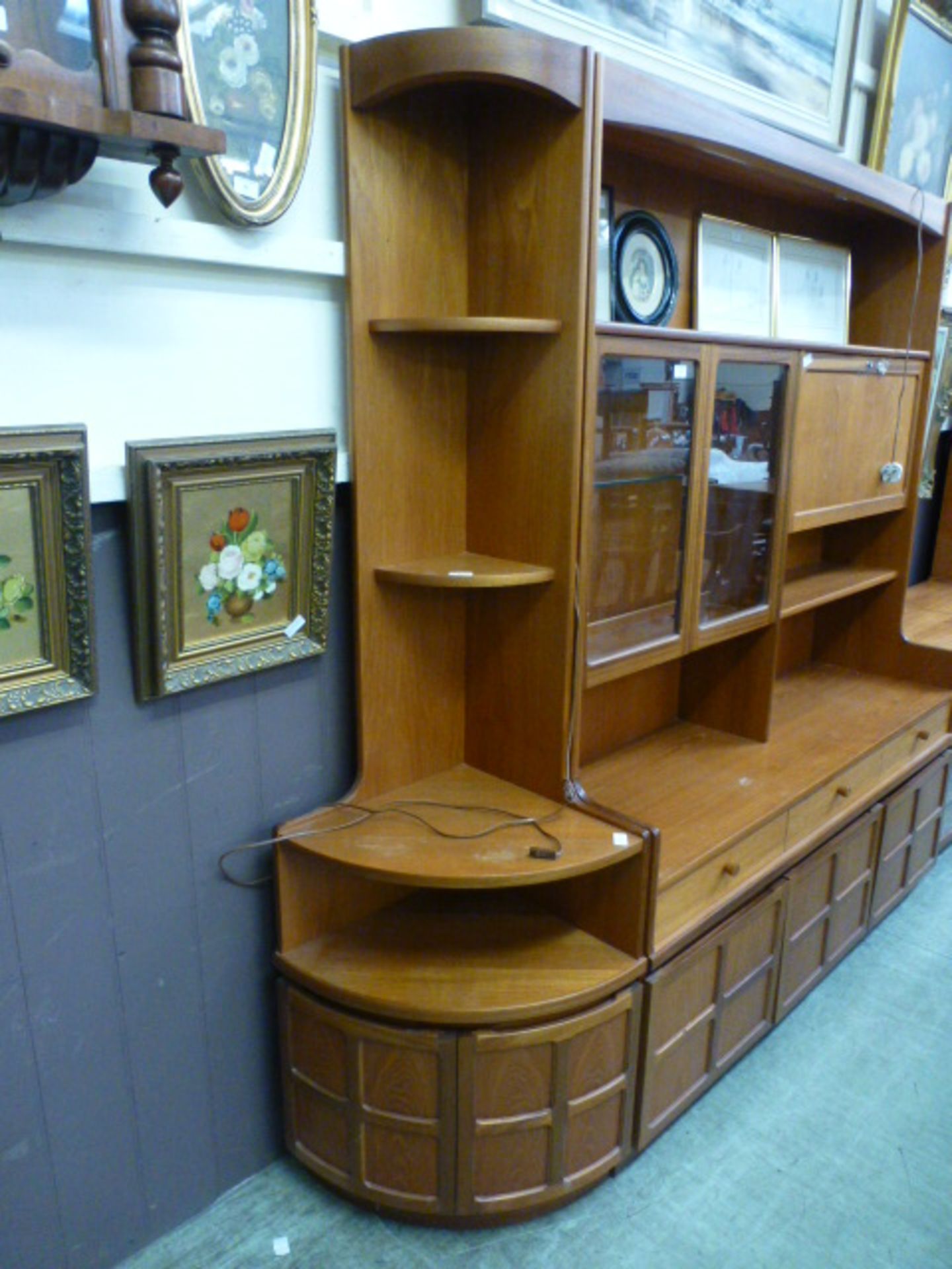 A full height mid-20th century design teak corner cabinet having open torage above a pair of doors