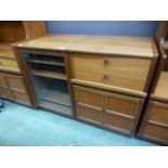 A mid-20th century design cabinet having a glazed door with drawer and cupboard by Nathan