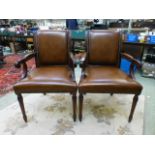 A pair of high quality reproduction tan leather upholstered open armchairs