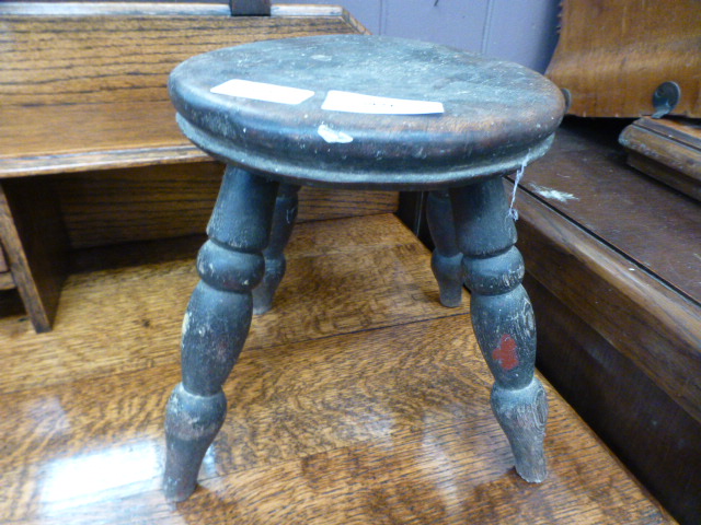 A small four legged milking stool