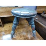 A small four legged milking stool
