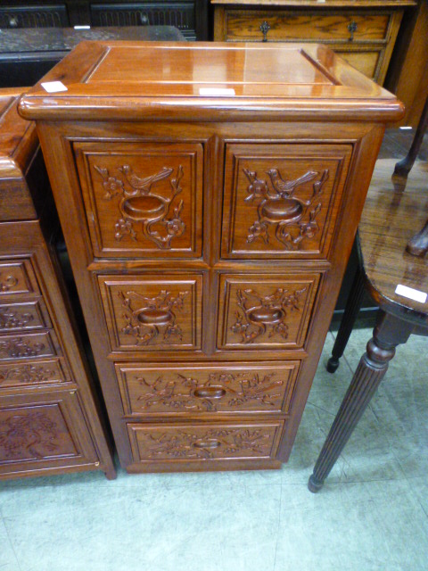 A Chinese hardwood bank of six drawers with bird design