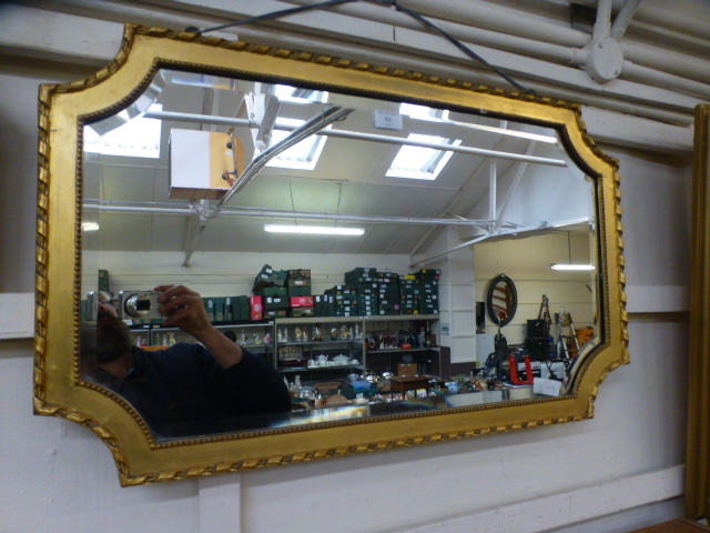 A gilt framed bevel glass wall mirror