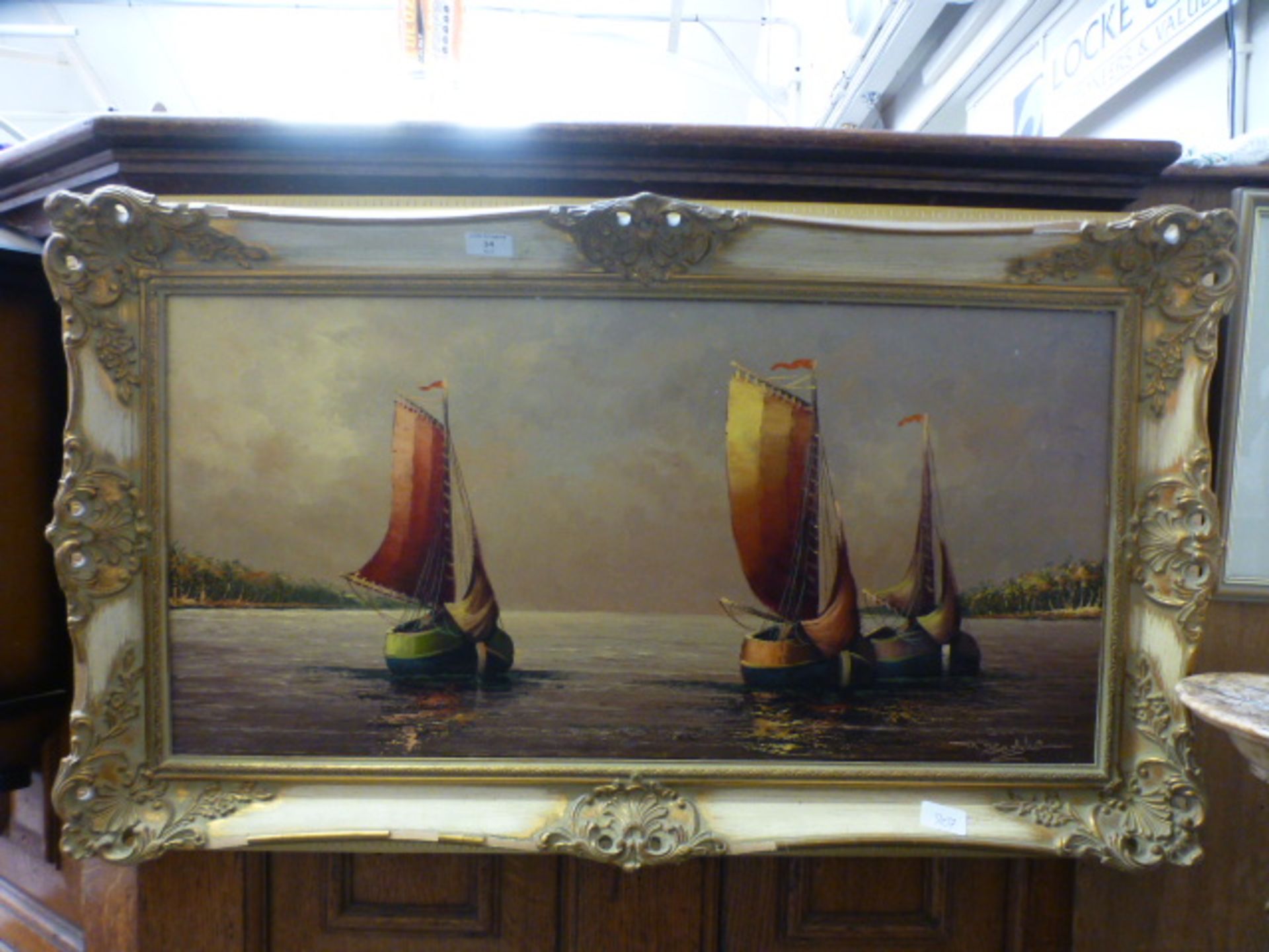 A gilt framed oil on canvas of sailing boats signed T.