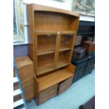 A mid-20th century teak cabinet having a pair of glazed doors above a pair of cupboard doors