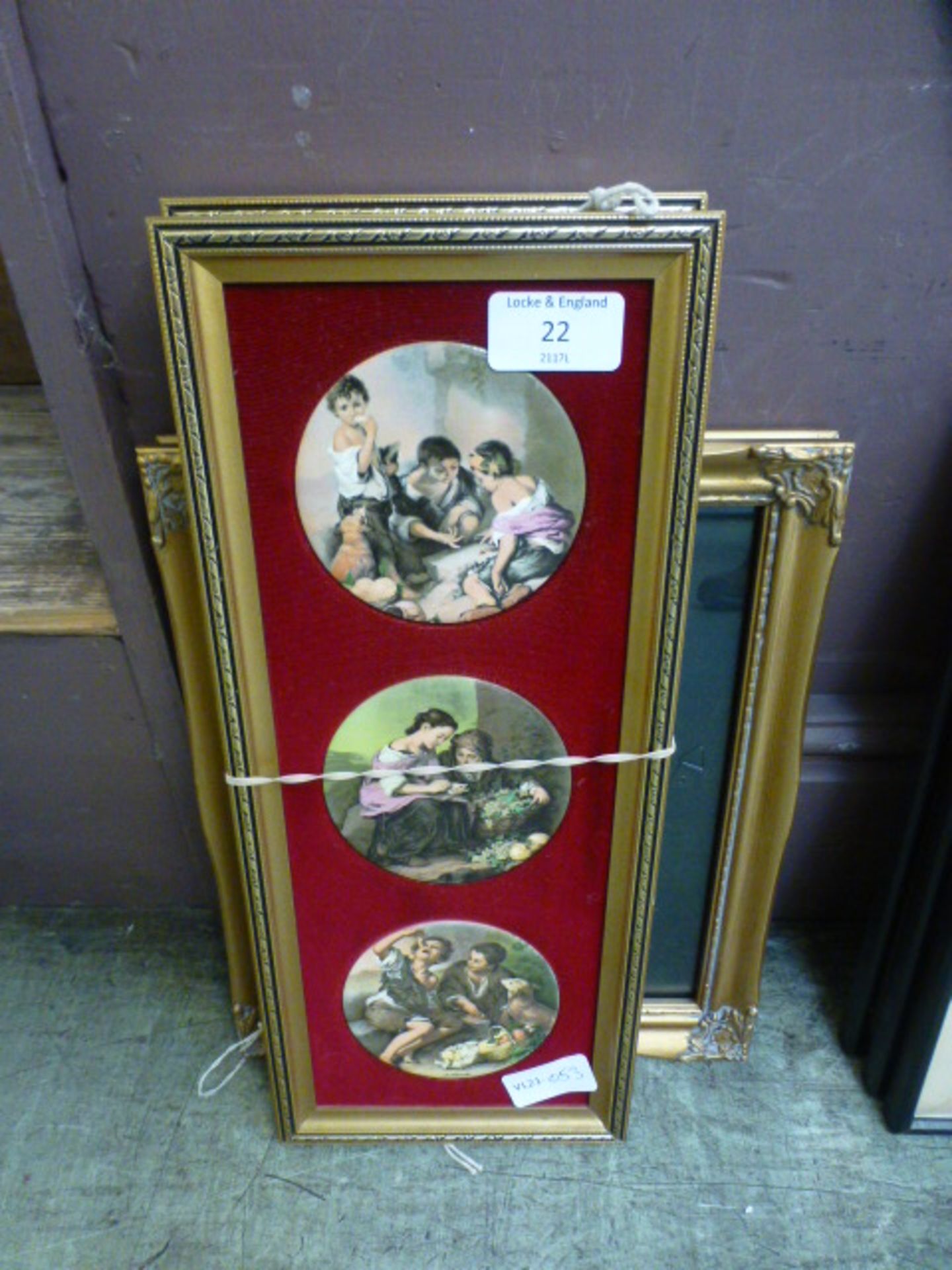 A pair of modern gilt framed pot lid style plaques together with a gilt picture frame