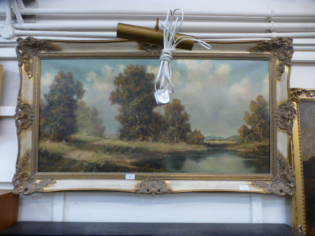 A gilt framed oil on canvas of a country lake scene