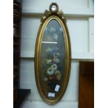 An ornate gilt oval framed and glazed oil of still life signed at bottom