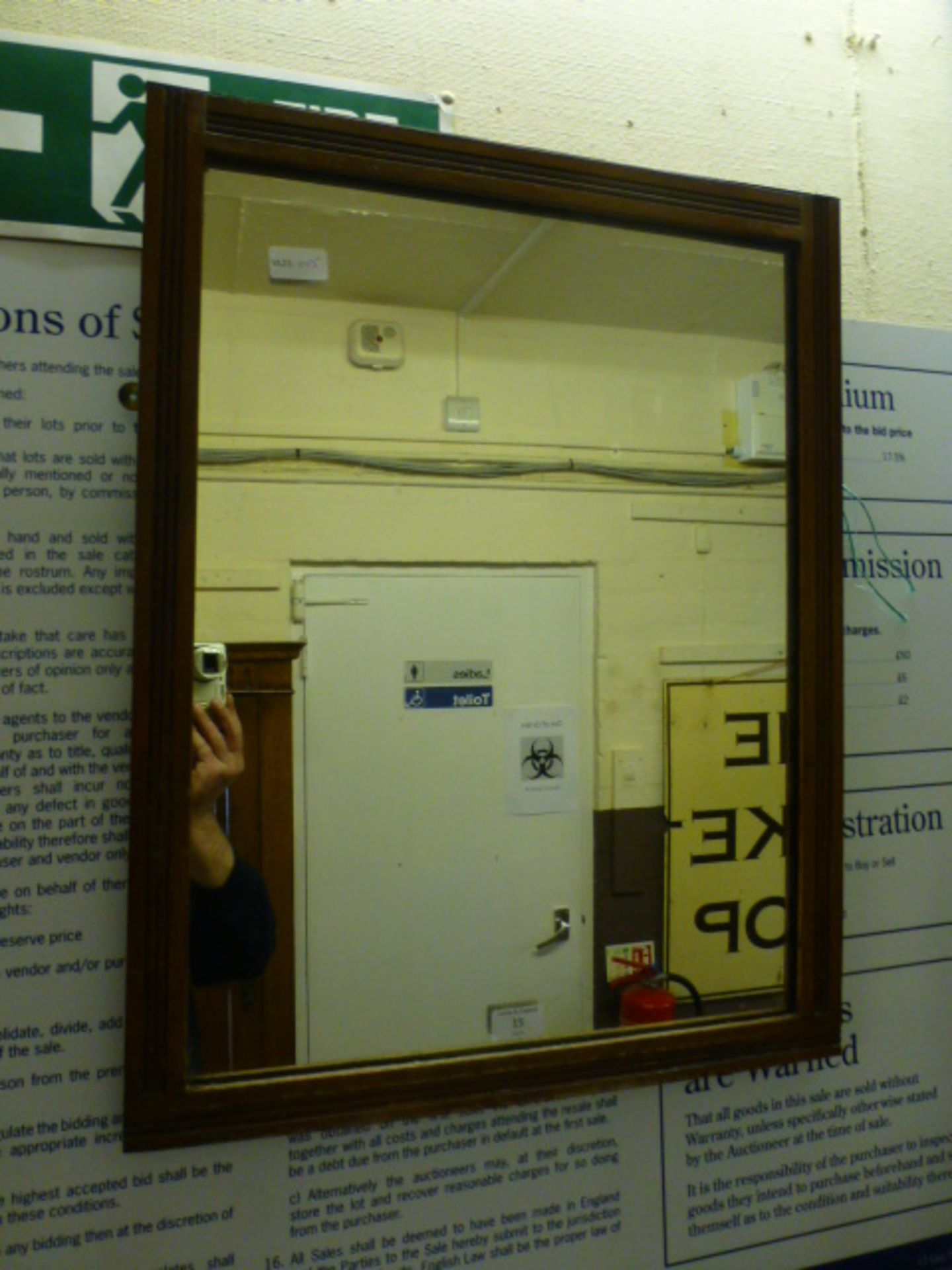 An early 20th century walnut framed wall mirror