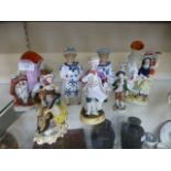 A collection of continental ceramic figures together with two Staffordshire flat backs
