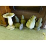 A selection of four weathered concrete finials together with a twin handled urn and a modern