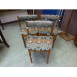 Three mid-20th century teak dining chairs upholstered in a Liberty design fabric