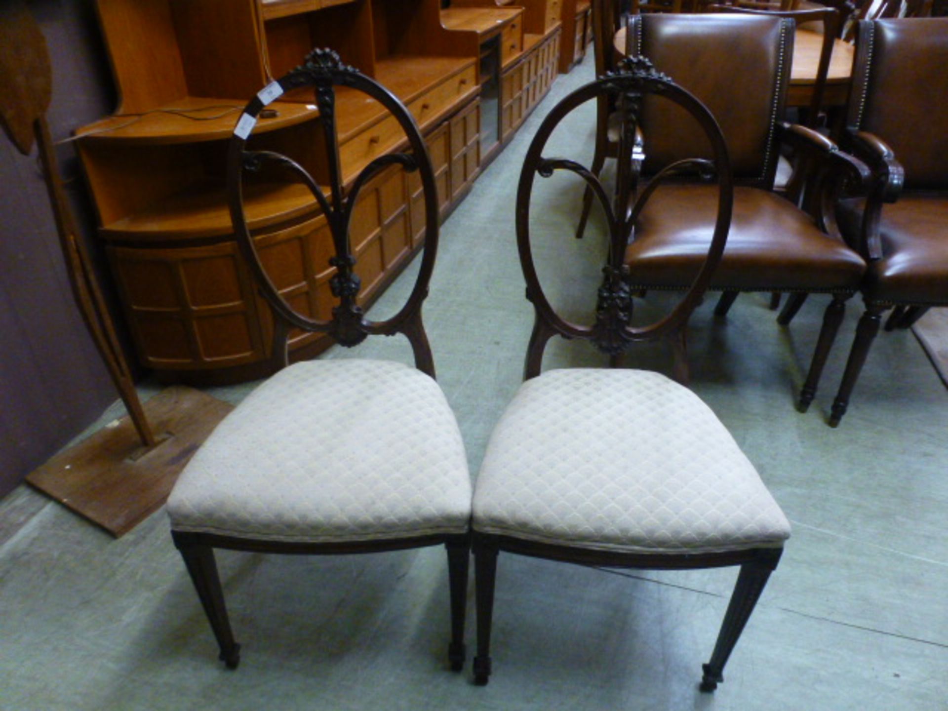 A pair of early 20th century mahogany balloon back hall chairs
