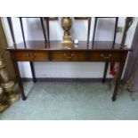 A reproduction mahogany three drawer serving table on square tapering supports