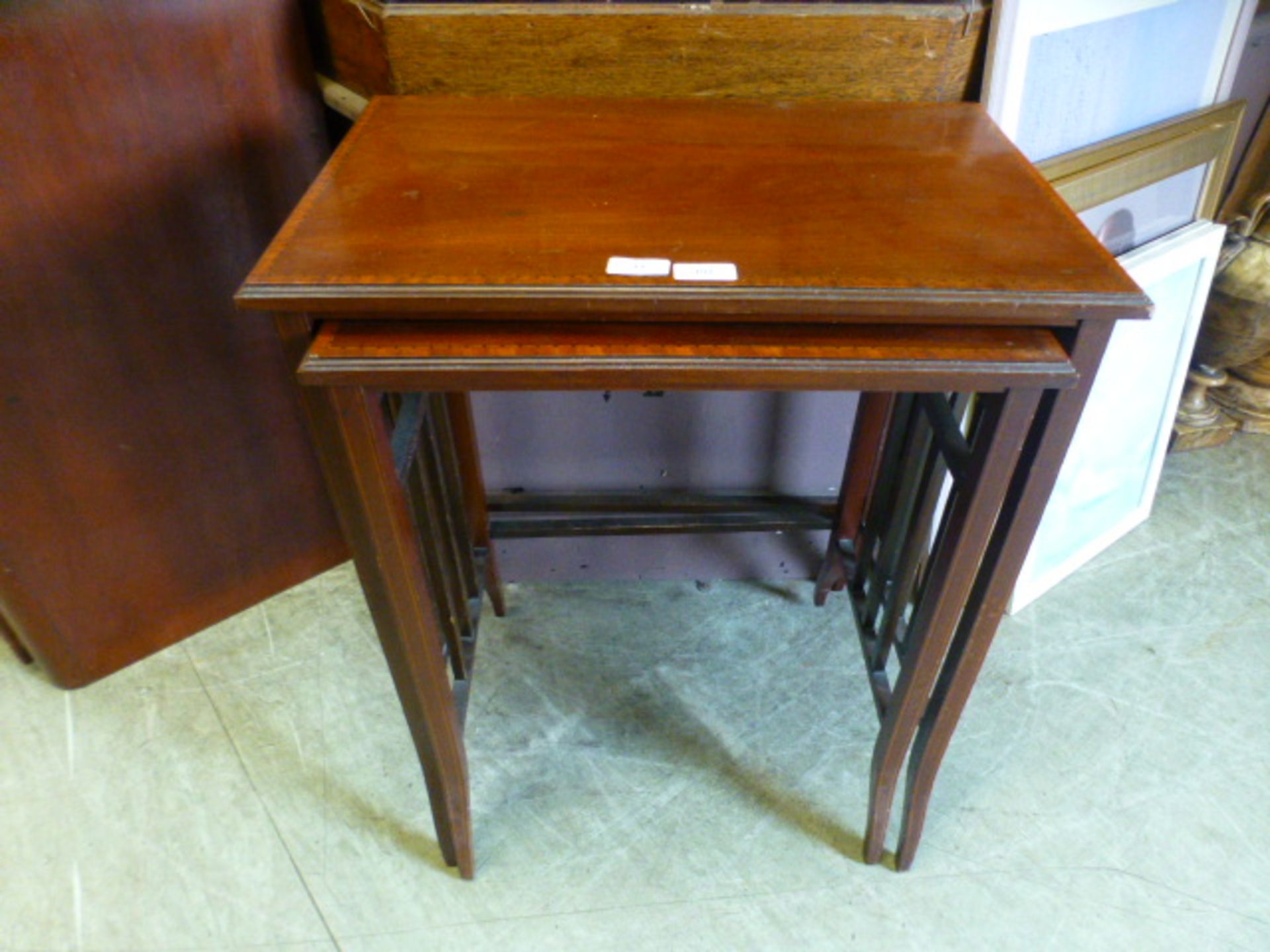 A nest of two early 20th-century mahogany occasional tables