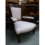 An Edwardian walnut framed salon chair upholstered in a cream cut fabric
