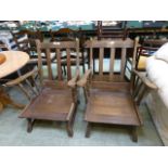 A pair of early 20th century oak open armchairs