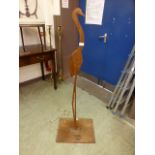 A teak sculpture of a stork