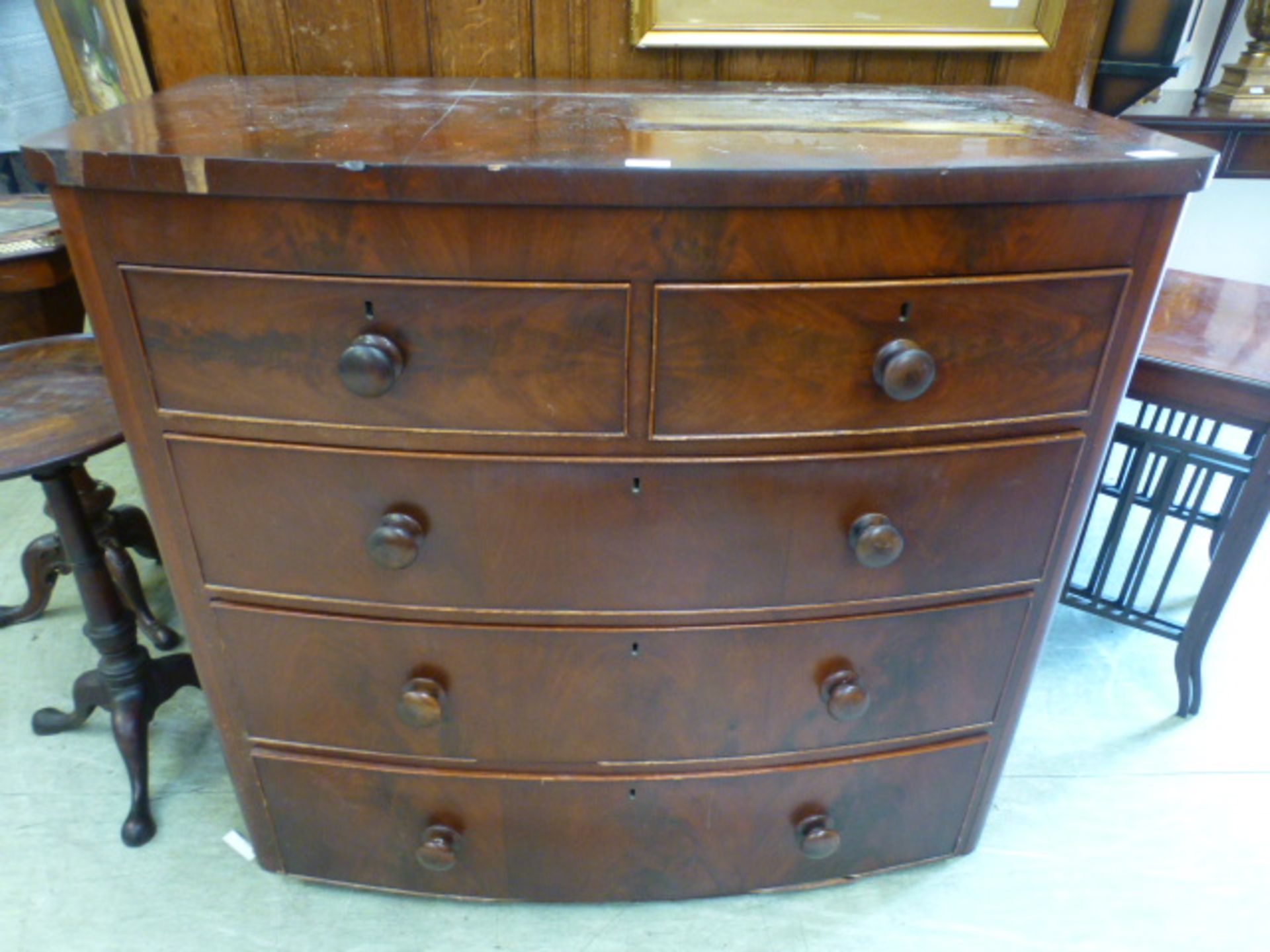 An 19th century flame mahogany bow fronted chest of two short over three long drawers