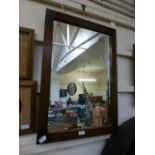 An oak framed rectangular wall mirror