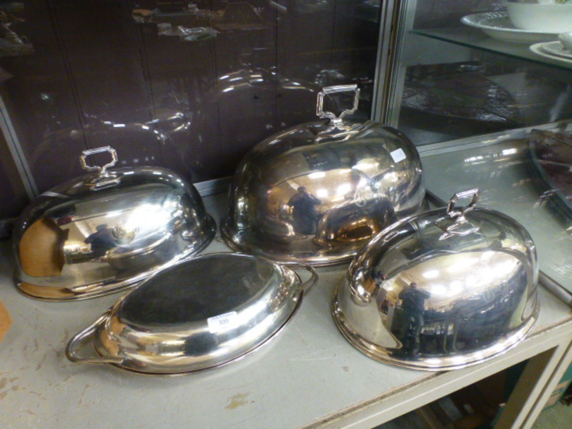 Three silver plated cloches together with one other dish