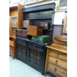 A mid-20th century dark oak dresser having plate rack to top,