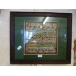 A framed and glazed sampler dated 1889