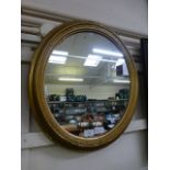 An oval gilt framed wall mirror