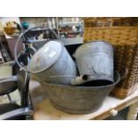 Two galvanized watering cans together with galvanized bucket and a bath