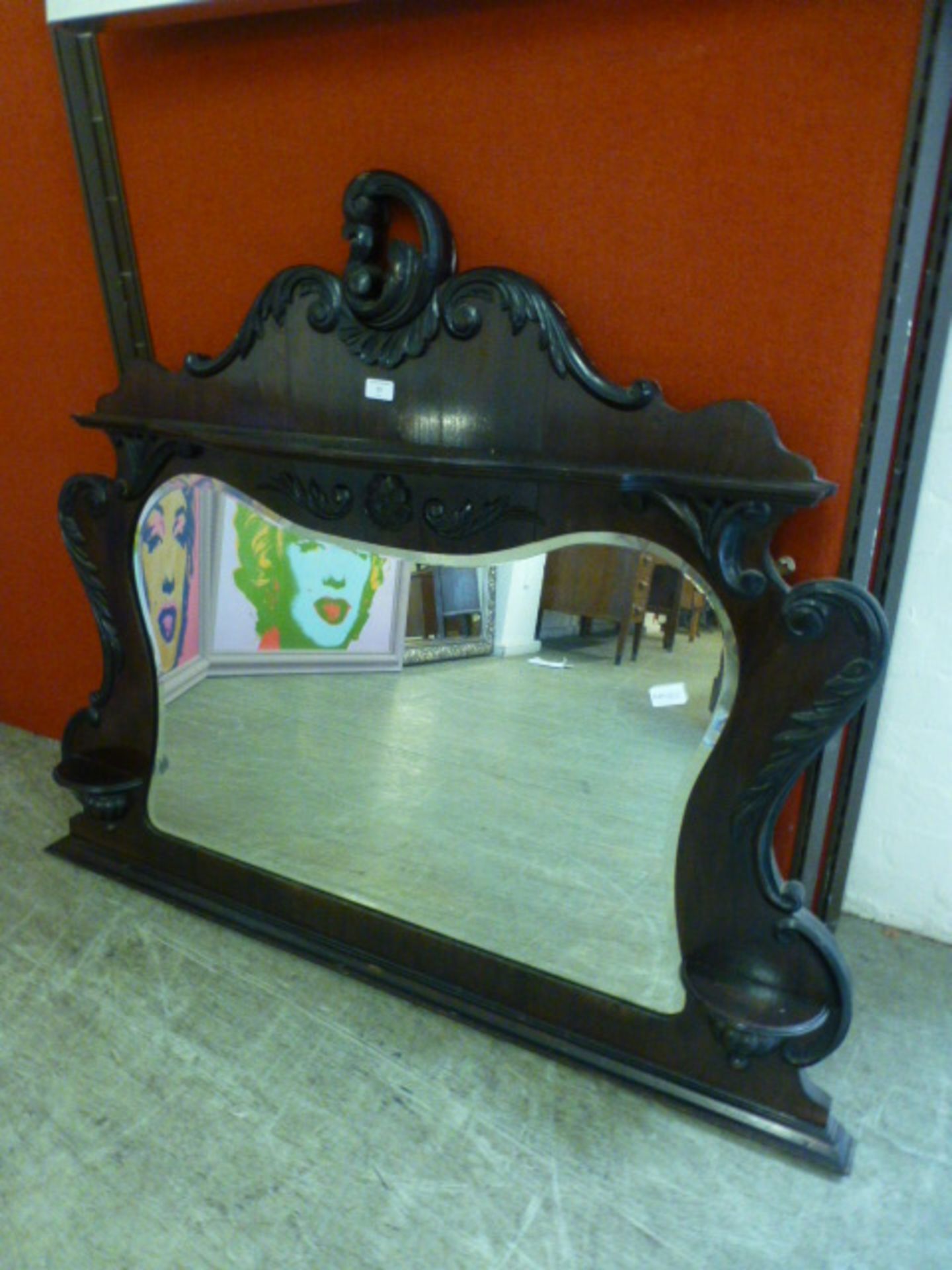 An early 20th century walnut bevelled glass overmantle mirror