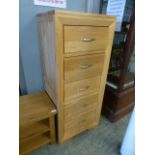 A modern oak five drawer chest with brushed chrome handles