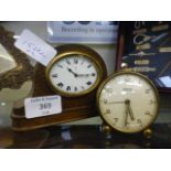 A miniature German oak cased mantle clock together with a small brass circular alarm clock by Swiza