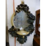 A moulded plaster mirror with vine design