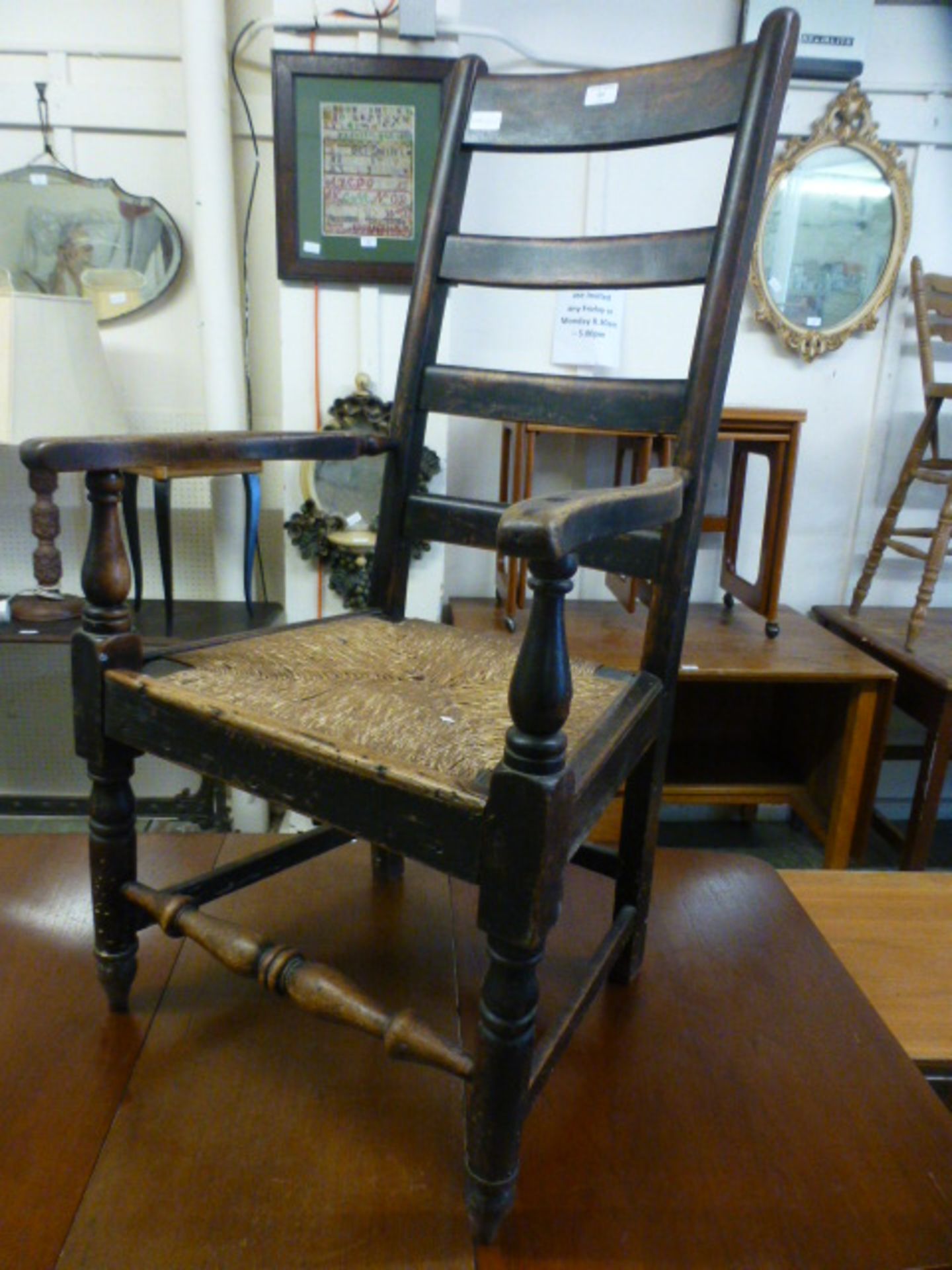 A 19th century alder ladder back open armchair with sea grass seat