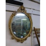 A cream and parcel gilt oval mirror