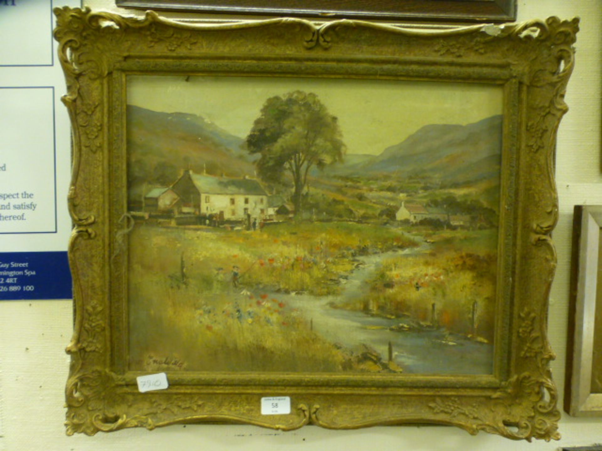 A gilt framed oil on canvas of young boy fishing by cottage signed bottom left