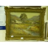 A gilt framed oil on canvas of young boy fishing by cottage signed bottom left