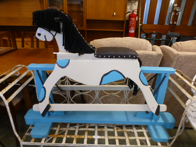 A hand crafted blue and cream painted child's rocking horse