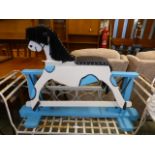 A hand crafted blue and cream painted child's rocking horse